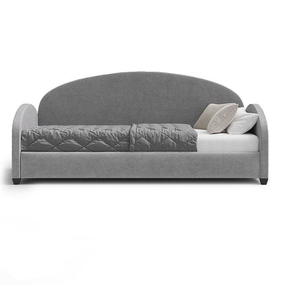 A modern gray upholstered daybed with a curved backrest, shown on a white background with a quilted gray cushion, white mattress, and three neutral throw pillows.